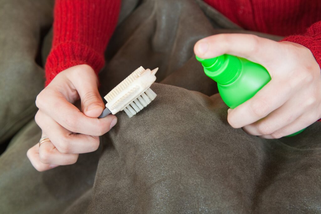woman-cleaning-sheepskin-with-whisk-broom-min
